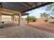 Private backyard with a pergola-covered patio and low-maintenance desert landscaping at 22815 N Arrellaga Dr, Sun City West, AZ 85375