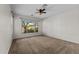 A bedroom with carpet floors, a ceiling fan, and a large window at 22815 N Arrellaga Dr, Sun City West, AZ 85375