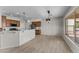 Open dining area with a hanging light fixture and a view into the kitchen at 22815 N Arrellaga Dr, Sun City West, AZ 85375