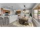 Open dining area with a stylish wood table and a view into the kitchen at 22815 N Arrellaga Dr, Sun City West, AZ 85375