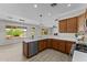 A kitchen with stainless steel appliances, light countertops and tile floors at 22815 N Arrellaga Dr, Sun City West, AZ 85375