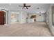 An open-concept living room with tile floors and neutral paint at 22815 N Arrellaga Dr, Sun City West, AZ 85375