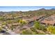 A scenic aerial view of a gated community with luxurious homes, red tile roofs, and mountain views at 2304 N Steele Cir, Mesa, AZ 85207