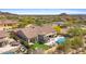 A beautiful home with a pool, putting green, outdoor fire pit, and covered patios in a gated community at 2304 N Steele Cir, Mesa, AZ 85207
