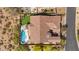 An aerial shot of a backyard with a pool, putting green, outdoor fire pit, and covered patios at 2304 N Steele Cir, Mesa, AZ 85207
