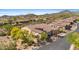 A luxurious home with a red tile roof and lush landscaping is in a gated community at 2304 N Steele Cir, Mesa, AZ 85207