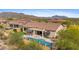 A beautiful backyard with a pool, putting green, outdoor fire pit, and covered patios at 2304 N Steele Cir, Mesa, AZ 85207