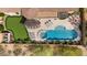 Aerial shot of luxurious backyard with pool, spa, putting green, lounge area, and outdoor fireplace at 2304 N Steele Cir, Mesa, AZ 85207