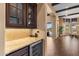 Elegant bar area equipped with wine storage, granite countertop, and tiled backsplash at 2304 N Steele Cir, Mesa, AZ 85207