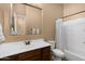 Cozy bathroom with wooden vanity, combined tub and shower, and neutral color scheme at 2304 N Steele Cir, Mesa, AZ 85207