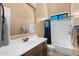 Bathroom featuring a single sink vanity and a tub shower with a framed window at 2304 N Steele Cir, Mesa, AZ 85207
