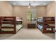 Bedroom featuring two sets of wooden bunk beds and a window with natural light at 2304 N Steele Cir, Mesa, AZ 85207