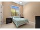 Bedroom featuring a patterned comforter, accent window, and dual night stands at 2304 N Steele Cir, Mesa, AZ 85207
