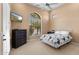Comfortable bedroom with a ceiling fan, television, and plenty of natural light from a large window at 2304 N Steele Cir, Mesa, AZ 85207