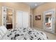 Bright bedroom featuring a newsprint-themed bedspread and sliding closet doors at 2304 N Steele Cir, Mesa, AZ 85207