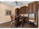 Stylish dining area with dark wood cabinets and furniture, next to a wine refrigerator at 2304 N Steele Cir, Mesa, AZ 85207