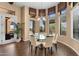 Bright breakfast nook showcases a glass table, neutral chairs, and backyard views at 2304 N Steele Cir, Mesa, AZ 85207