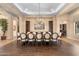 Elegant dining room featuring a large table with seating for fourteen beneath a decorative chandelier at 2304 N Steele Cir, Mesa, AZ 85207