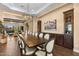 Formal dining area features designer lighting, custom cabinetry, and ample seating for guests at 2304 N Steele Cir, Mesa, AZ 85207