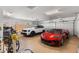 Organized garage featuring epoxy floors, storage cabinets, and parking space for two cars and a bicycle at 2304 N Steele Cir, Mesa, AZ 85207