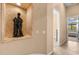 Hallway with golf themed art niche leading to a bedroom with natural light and a ceiling fan at 2304 N Steele Cir, Mesa, AZ 85207