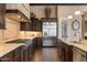 Well-equipped kitchen has granite counters, stainless appliances, and dark wood cabinets at 2304 N Steele Cir, Mesa, AZ 85207