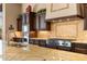 Close-up of kitchen featuring a stainless steel range, tile backsplash, and granite countertops at 2304 N Steele Cir, Mesa, AZ 85207