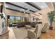 Open concept living room with wood beams, a fireplace, and access to the outdoor area at 2304 N Steele Cir, Mesa, AZ 85207