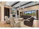 Large open living room featuring wood beams, comfortable seating, and a stone fireplace at 2304 N Steele Cir, Mesa, AZ 85207