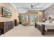 Large bedroom featuring a flat screen television, sitting chairs, and access to the backyard at 2304 N Steele Cir, Mesa, AZ 85207