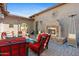 Covered outdoor seating area with comfortable seating, a brick fireplace, and privacy at 2304 N Steele Cir, Mesa, AZ 85207
