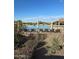 Outdoor swimming pool surrounded by lounge chairs, desert landscaping, and shaded cabanas offers relaxation and recreation at 2304 N Steele Cir, Mesa, AZ 85207