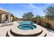 Inviting pool and spa area surrounded by a stone patio, offering a relaxing and luxurious outdoor experience at 2304 N Steele Cir, Mesa, AZ 85207