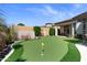 Backyard putting green with manicured landscaping, providing a private recreational space for golf enthusiasts at 2304 N Steele Cir, Mesa, AZ 85207