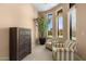 Comfortable sitting room with two chairs, a chest of drawers, and large windows at 2304 N Steele Cir, Mesa, AZ 85207