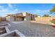 A spacious backyard with gravel landscaping, patio area, and block fence for privacy at 23829 N 36Th Dr, Glendale, AZ 85310
