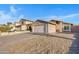 A single-story home with a two-car garage and desert landscaping offering curb appeal at 23829 N 36Th Dr, Glendale, AZ 85310