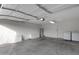 Spacious garage with storage cabinets, washer, dryer, and overhead door at 23829 N 36Th Dr, Glendale, AZ 85310