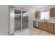 Kitchen area with sliding glass doors, cabinets and stainless steel dishwasher at 23829 N 36Th Dr, Glendale, AZ 85310