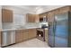 Kitchen featuring stainless appliances, tile flooring, and neutral countertops at 23829 N 36Th Dr, Glendale, AZ 85310