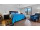 Comfortable bedroom boasts a large window, ceiling fan, and wood-look floors at 2757 Leisure World --, Mesa, AZ 85206