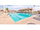 A large community pool with a covered lounging area for residents, set against a partly cloudy sky at 2757 Leisure World --, Mesa, AZ 85206