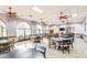 Spacious dining room with large windows, multiple tables and chairs, perfect for large gatherings and events at 2757 Leisure World --, Mesa, AZ 85206