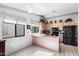Bright kitchen featuring tile floors, wood cabinets, and a black refrigerator at 2757 Leisure World --, Mesa, AZ 85206
