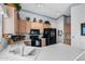 Functional kitchen featuring light wood cabinets, black appliances, and white countertops with plenty of natural light at 2757 Leisure World --, Mesa, AZ 85206
