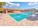 Large community pool with plenty of seating and a covered patio area for relaxation at 2757 Leisure World --, Mesa, AZ 85206