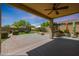 A spacious backyard with the patio, a fire pit, string lights, and many decorations at 29706 N 127Th Ln, Peoria, AZ 85383