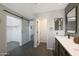 An open bathroom featuring the sink and a view into the closet and other rooms at 29706 N 127Th Ln, Peoria, AZ 85383