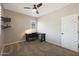 Bedroom with carpet, a ceiling fan, a desk, and modern decor at 29706 N 127Th Ln, Peoria, AZ 85383
