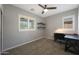 Bedroom with neutral-toned walls and carpet, desk, shelves, and window with shutters at 29706 N 127Th Ln, Peoria, AZ 85383